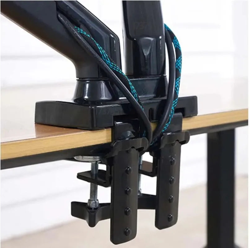 Dual monitor arm securely clamped to desk edge with cable management, minimalist workspace