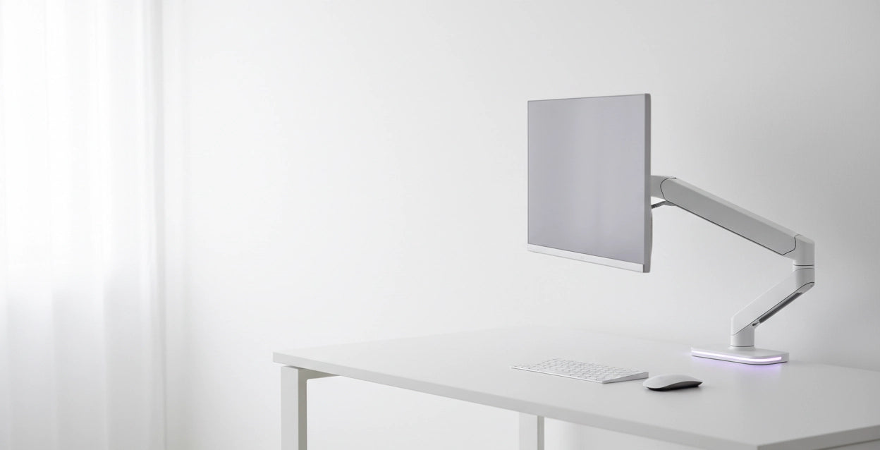 Modern desk setup with a monitor on a white surface